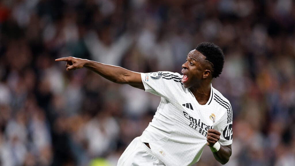 Vinicius Jr celebrates passionately after scoring a goal for Real Madrid against Arsenal in the UEFA Champions League quarterfinal second leg. - crosssportscentral.com Vinicius Jr celebrates passionately after scoring a goal for Real Madrid against Arsenal in the UEFA Champions League quarterfinal second leg.